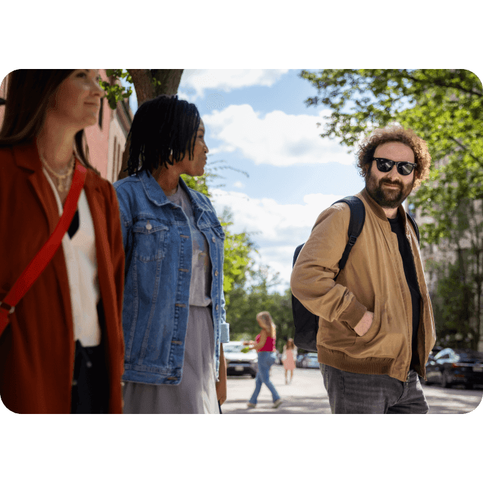 3 people walking across street